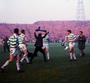 Scottish league Cup Final 1965 Rangers versus Celtic A Rangers supporter runs onto the pitch to attack the Celtic team Hughes holding cup sdrscottishcupfinal